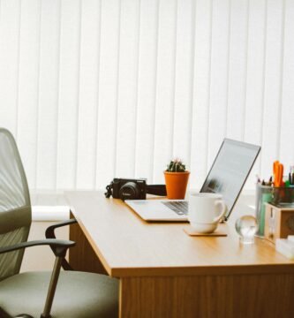 A clean and bright home office setup with a laptop, chair, and desk essentials.